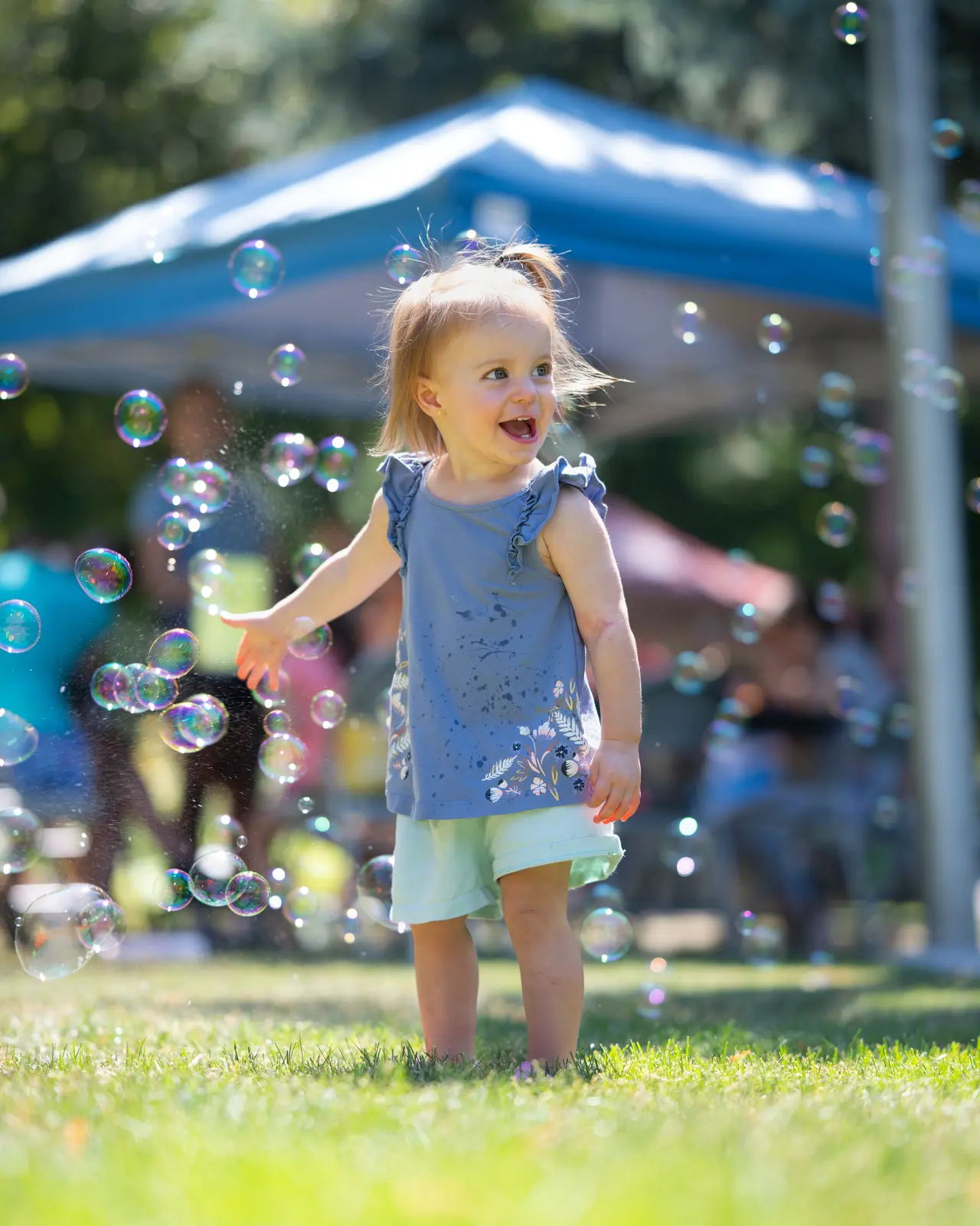A toddler chasing bubbles at Rendezvous for Kids