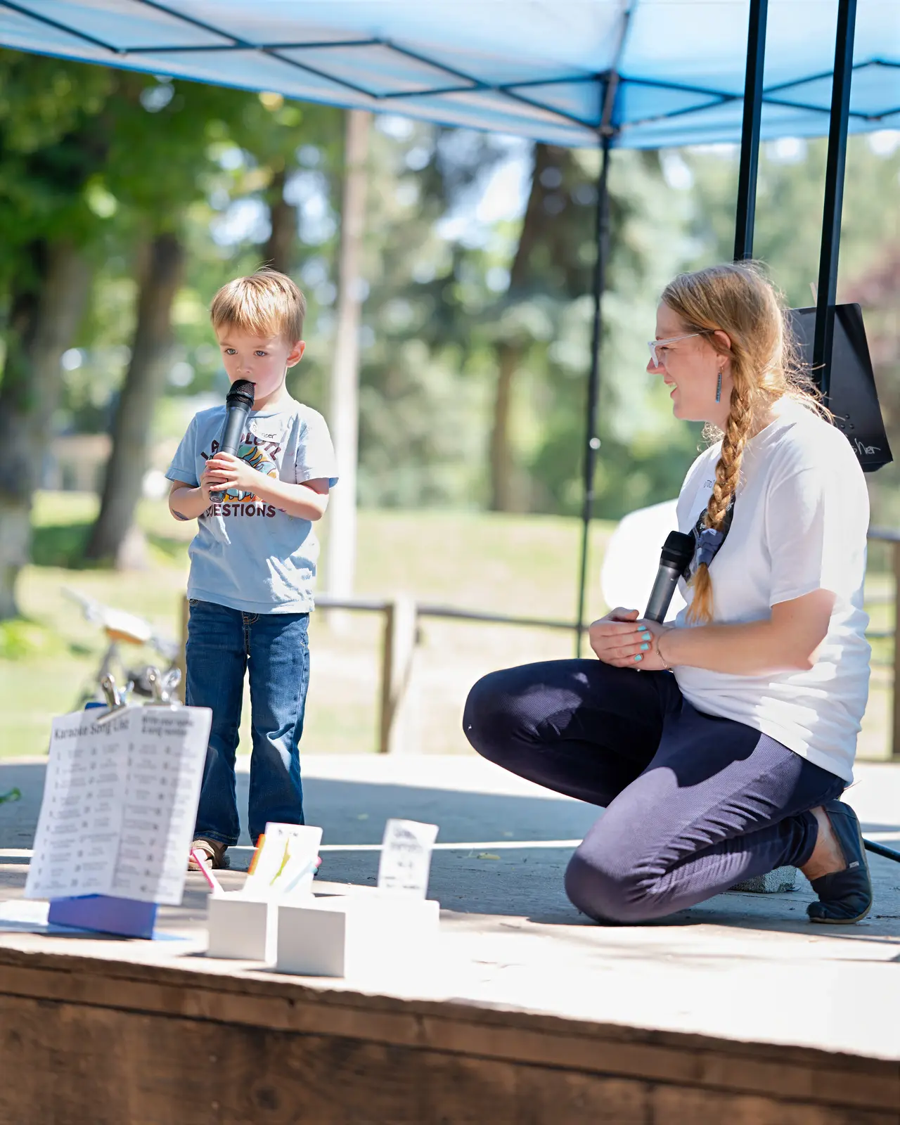 A child singing on stage at Rendezvous for Kids