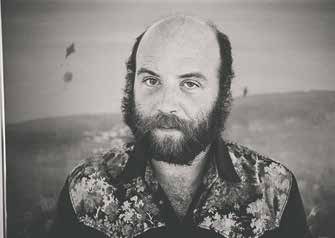 Black-and-white portrait of Bart Budwig, bearded and wearing a patterned shirt.